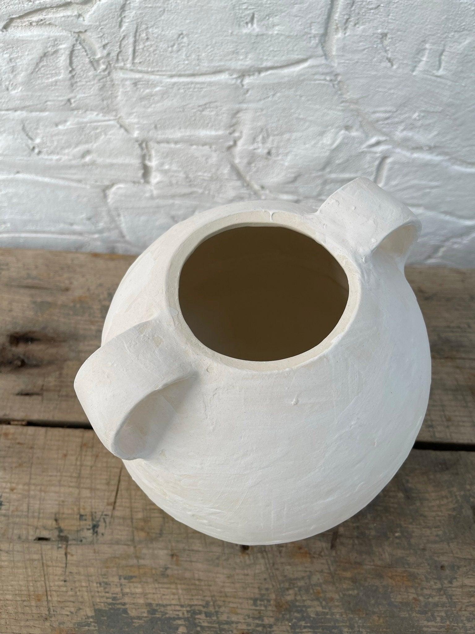 Handmade globe-shaped ceramic vessel with handles in a neutral glaze