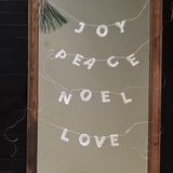 Handmade porcelain holiday word garland on European linen twine