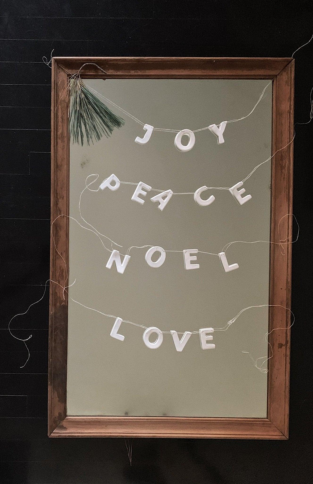 Handmade porcelain holiday word garland on European linen twine