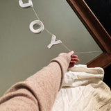 Handmade porcelain holiday word garland on European linen twine