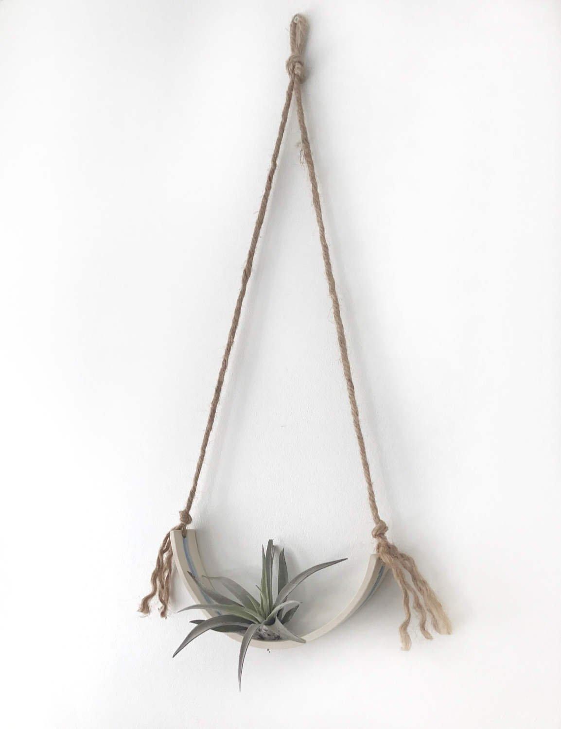 Handmade porcelain half-moon wall planter with watercolor glaze stripe holding an air plant by Muddy Heart