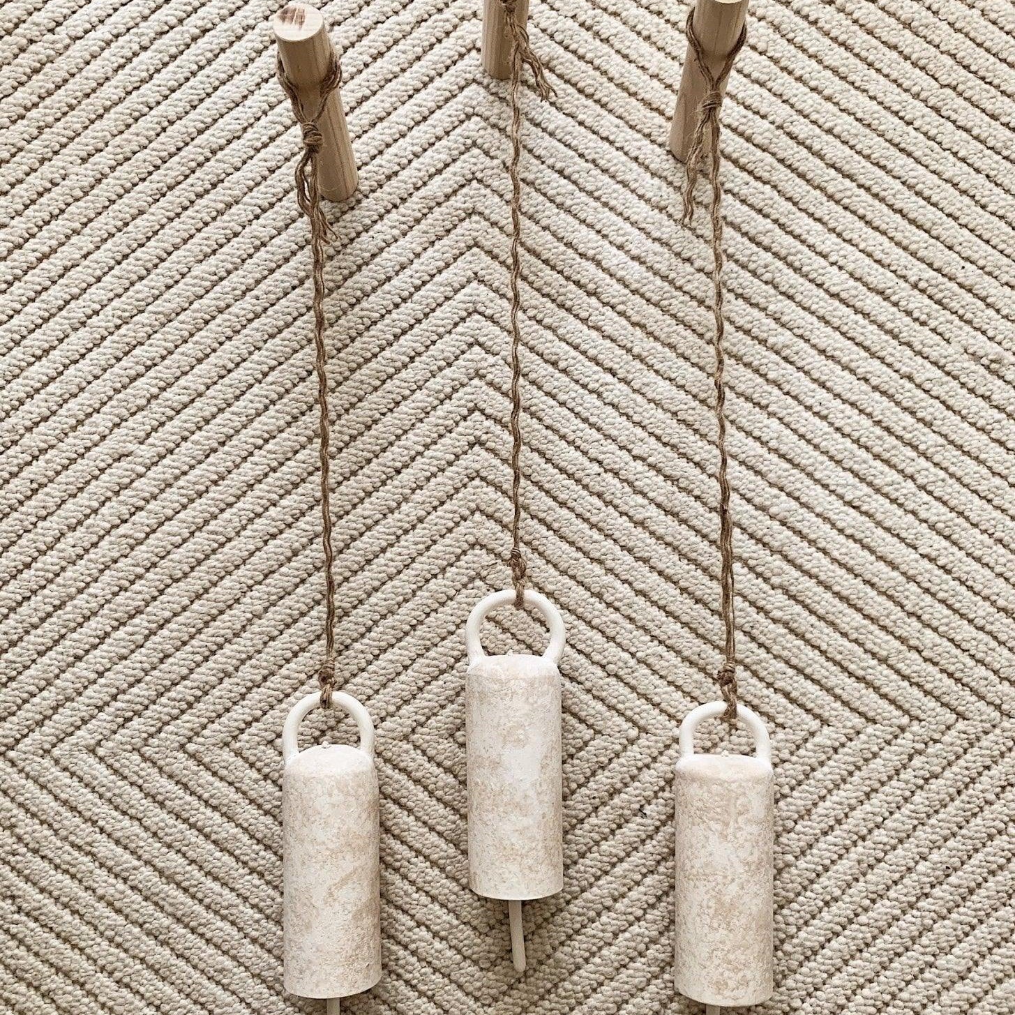 Handmade long ceramic bell with an elongated silhouette in a neutral finish