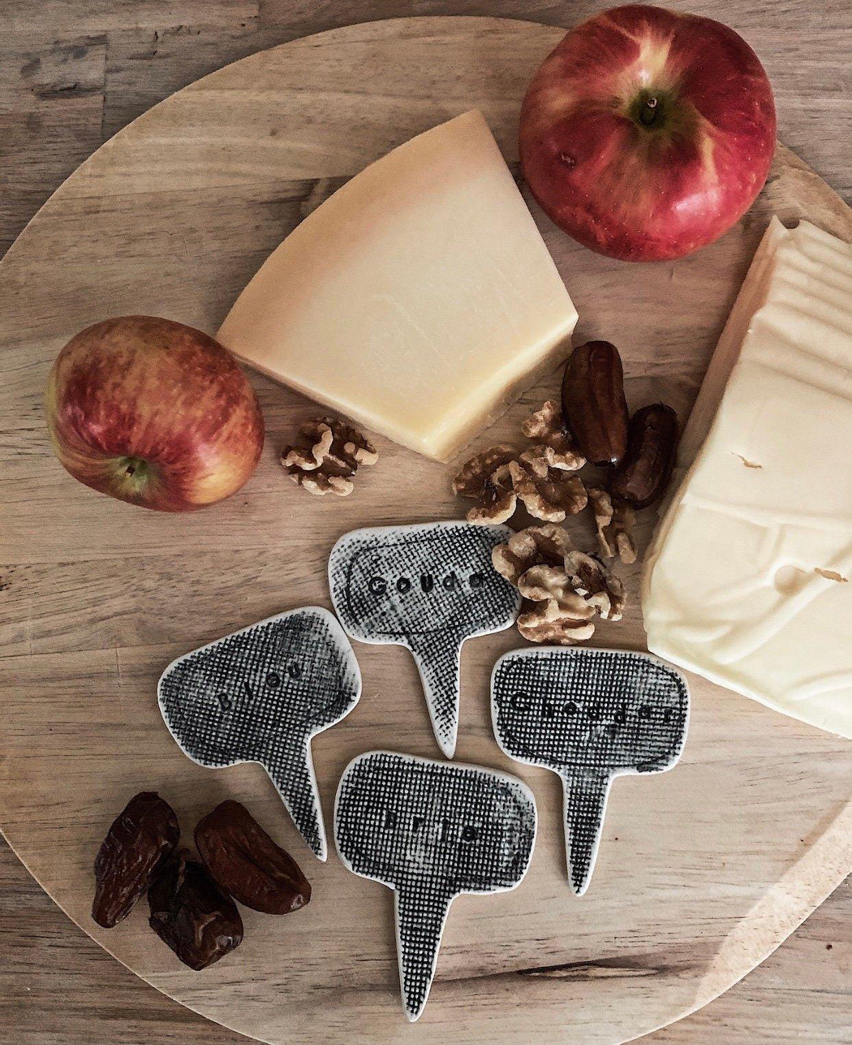 Handmade set of four porcelain cheese markers for a cheese board