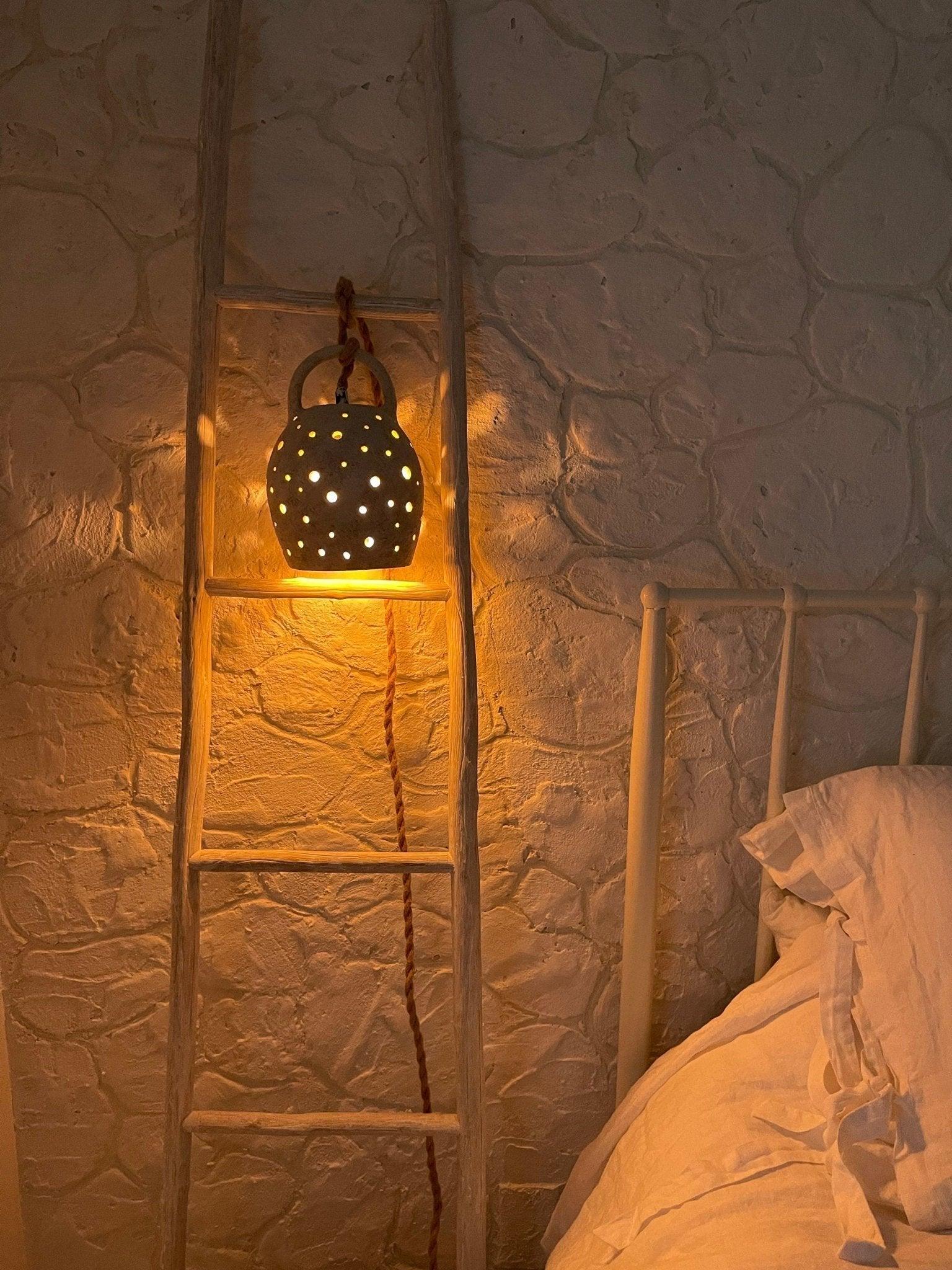 Handmade stoneware pendant lamp with hand-carved star cutouts