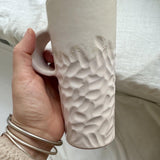 Handmade tall hand-carved ceramic mug in glossy white glaze